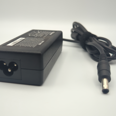 Black laptop power adapter with attached cord on white background.