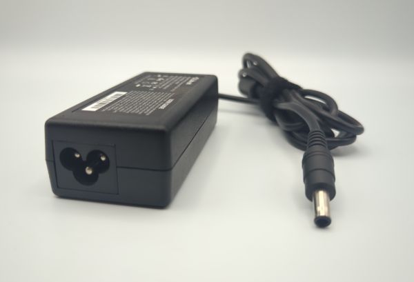 Black laptop power adapter with attached cord on white background.