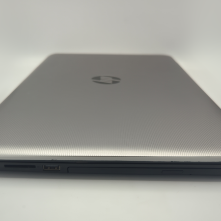 Silver laptop closed on a white background, showcasing sleek design and side ports.