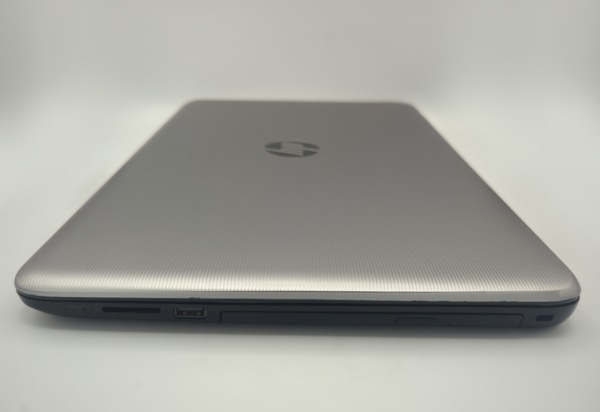 Silver laptop closed on a white background, showcasing sleek design and side ports.