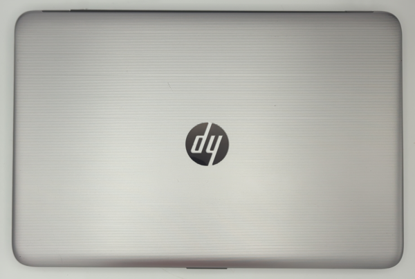 Silver laptop with horizontal stripes and a black logo at the center of the lid, viewed from above.