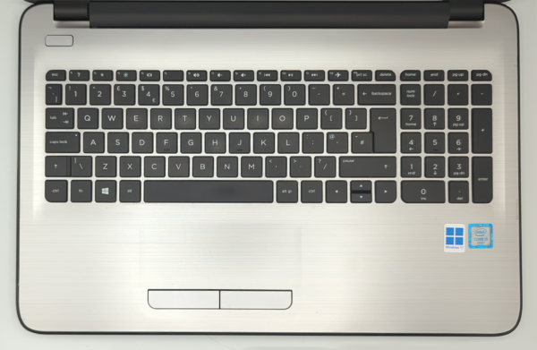 Laptop keyboard with numeric keypad, Windows 11 and Intel Core i5 stickers, silver finish.