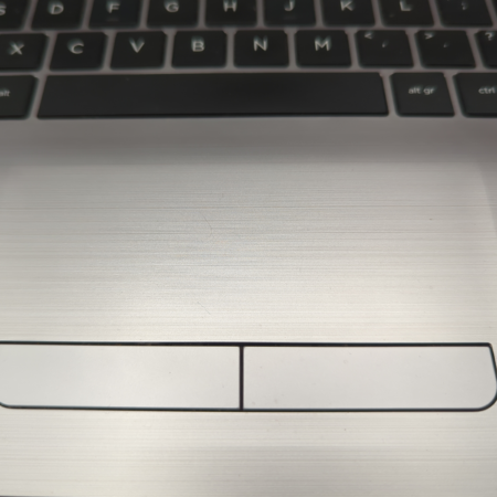 Close-up of a laptop touchpad with keyboard, highlighting navigation controls and button details.