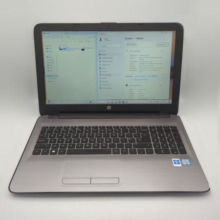 HP laptop displaying Windows system information on screen.