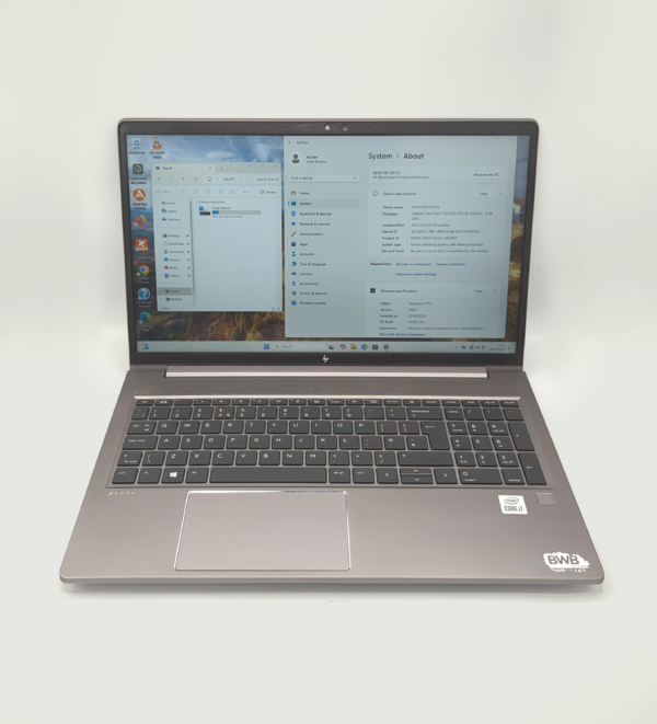 Open HP laptop displaying Windows system information on screen.