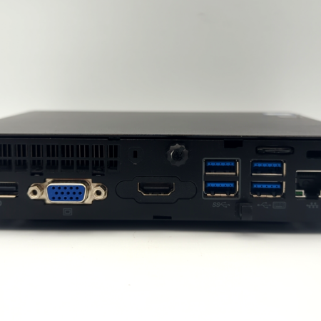 Back view of a black mini PC showing various ports including HDMI, USB, VGA, Ethernet, and power connector.