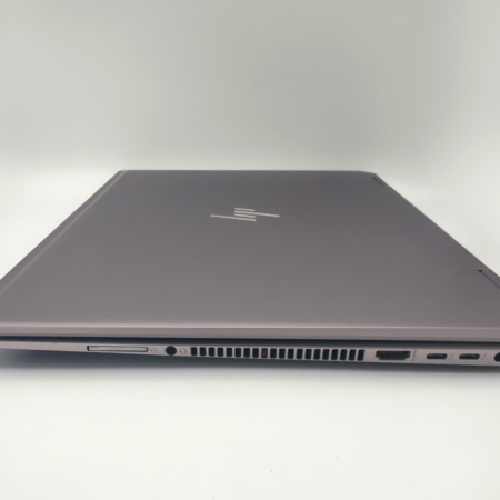 Closed laptop with multiple ports on the side, showcasing its slim and sleek design.
