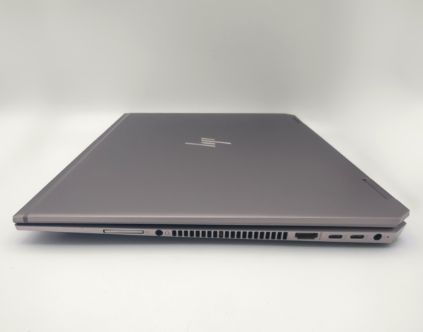 Closed laptop with multiple ports on the side, showcasing its slim and sleek design.