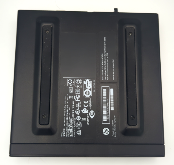 Black HP docking station bottom view, showing product labels and certification symbols on a white background.