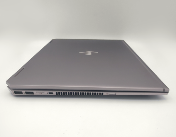 Silver closed laptop showing side ports and vents on a white background.