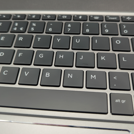 Close-up of a laptop keyboard showing QWERTY layout with black keys and white letters.