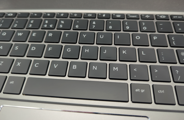 Close-up of a laptop keyboard showing QWERTY layout with black keys and white letters.