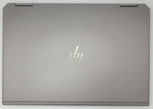 Closed HP laptop with logo on silver lid, top view.