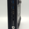 HP EliteDesk mini PC side view, featuring multiple USB ports and audio jacks.
