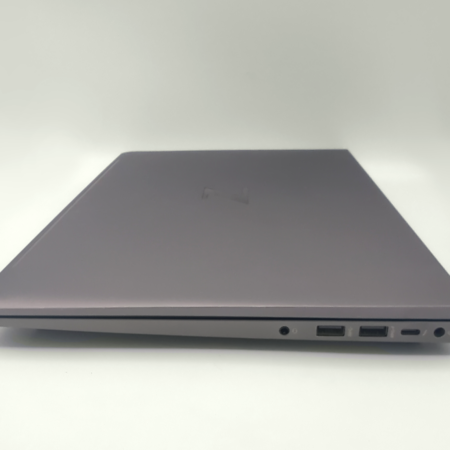 Closed gray laptop showing side ports on a white background.