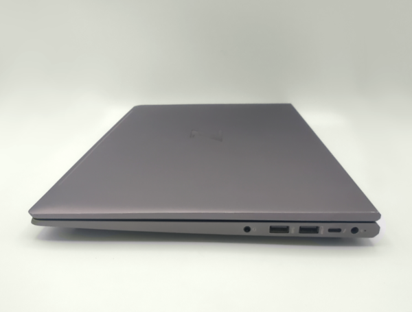 Closed gray laptop showing side ports on a white background.