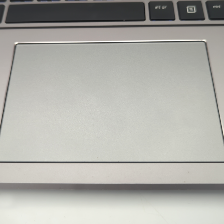Close-up of a laptop touchpad and keyboard, highlighting sleek and modern design.