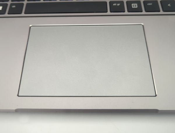 Close-up of a laptop touchpad and keyboard, highlighting sleek and modern design.