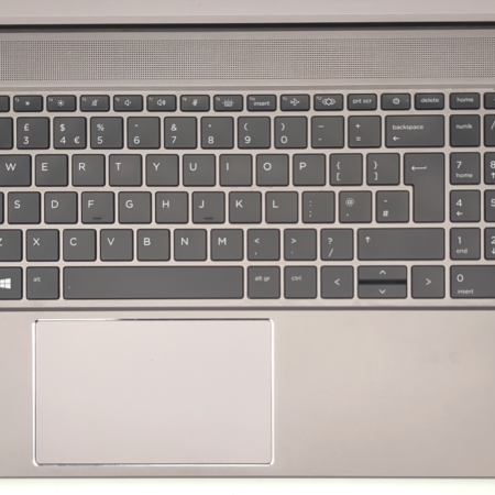 Silver laptop keyboard with numeric keypad, Intel Core i7 sticker, and wide touchpad for efficient typing and navigation.