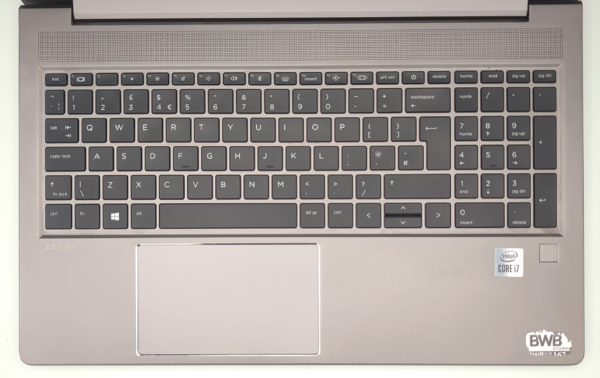 Silver laptop keyboard with numeric keypad, Intel Core i7 sticker, and wide touchpad for efficient typing and navigation.