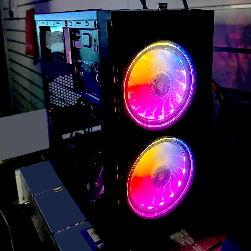 Gaming PC case with colorful RGB fans glowing in the dark, showcasing modern cooling technology.